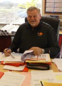 Ken Volkening, President of Fox Valley Fire & Safety, at his desk, 2023